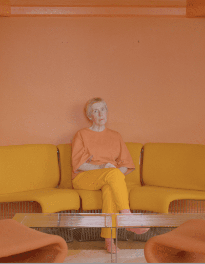 Protagonist sitting in an orange room